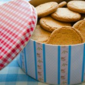 A cookie tin filled with cookies.