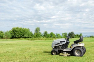 A riding lawn mower in a grassy field.