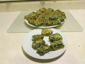 A plate of spinach and cheese appetizers.