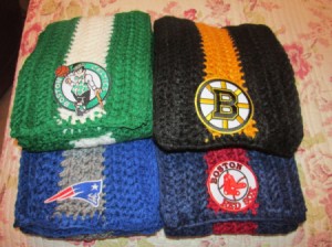 four crocheted team scarves