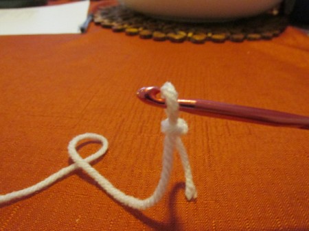 The start of a crochet project with white yarn.