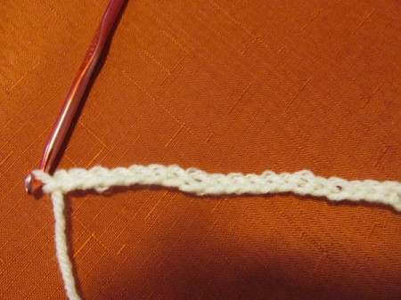 A crocheted chain in white yarn.