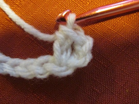 Continuing to crochet a white scarf.