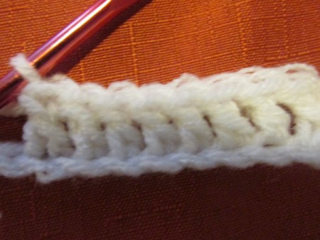 Continuing to crochet a white scarf.