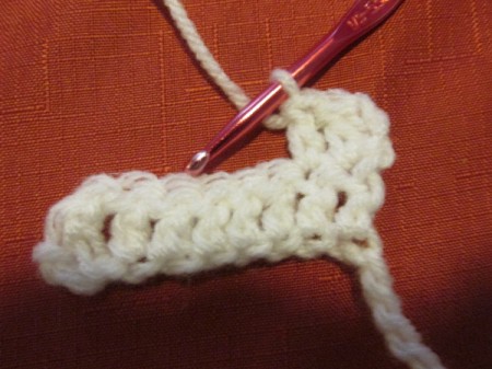 Continuing to crochet a white scarf.