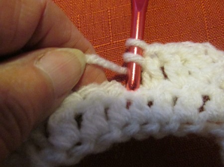 Continuing to crochet a white scarf.