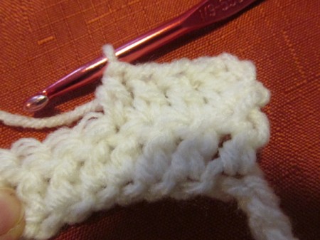 Continuing to crochet a white scarf.