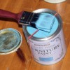 An elastic band stretched across the paint can opening.
