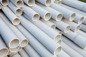 A large stack of PVC pipes.