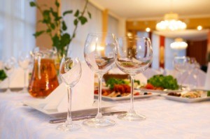 A nicely decorated banquet table with a white tablecloth.