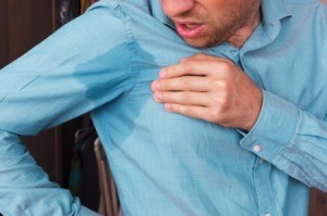 A man with wet underarms.