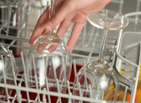 Some wine glasses in a dishwasher.