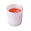 A votive candle holder with a red lit candle it in.