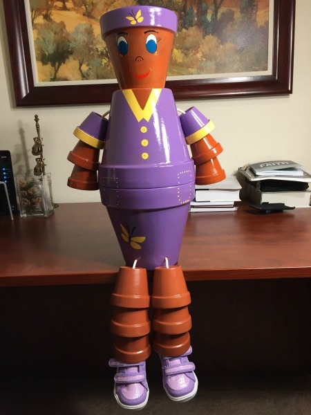 won in lavender dress and hat