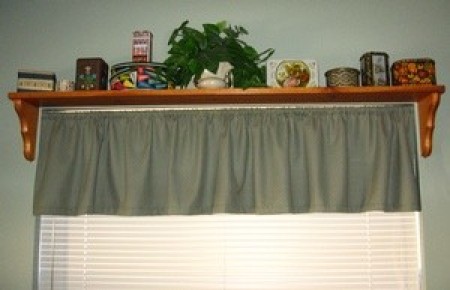 A space saving display shelf over a window.