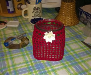 A crocheted covered candy jar.