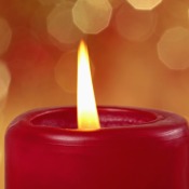 A burning red pillar candle.