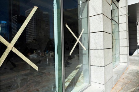 Windows with a masking tape "x" in the center, for protection.