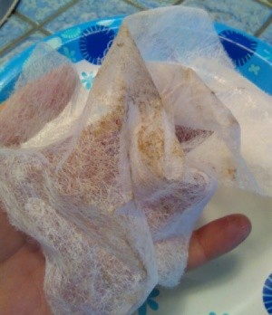 dust covered dryer sheet in woman's hand
