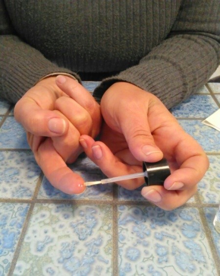 applying nail polish to cut