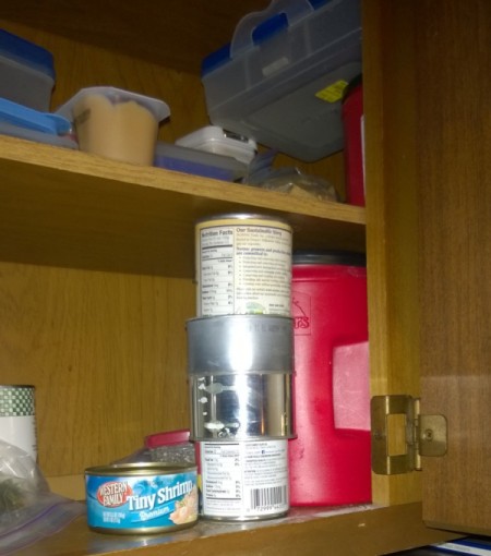 Two cans with a can stacker in the pantry.