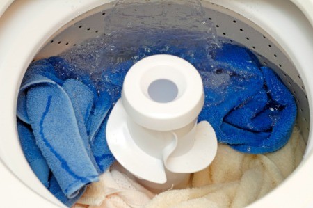 A washer full of clothes and water.