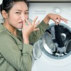 A woman washing stinky clothing.