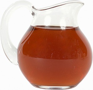 A glass pitcher full of tea.