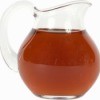 A glass pitcher full of tea.
