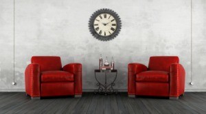 A pair of red leather chairs in a white room.