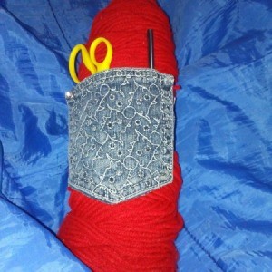 jeans pocket for storing a skein of yarn, scissors, and hook