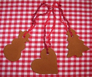 Three ornaments made from cinnamon and applesauce.