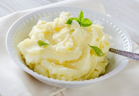 A dish of mashed potatoes with ranch dressing.
