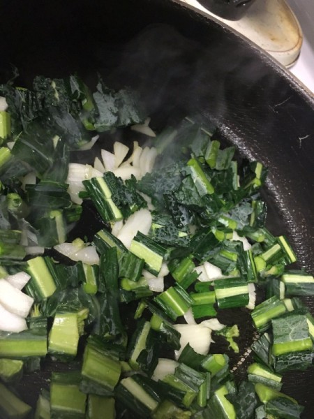chopped onion and kale in pan