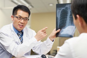 A doctor discussing a chest x-ray with a patient.