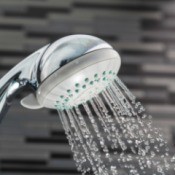A showerhead with water running.