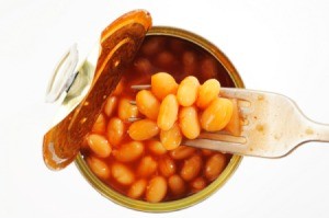 A open can of baked beans with a fork.