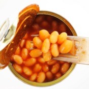 A open can of baked beans with a fork.