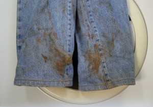 A pair of jeans with dirt stains.
