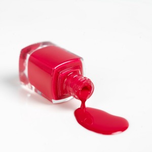 A spilled bottle of red nail polish.