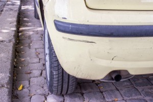 Black scuff marks on a car's bumper.
