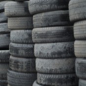 Tall stacks of used car tires.