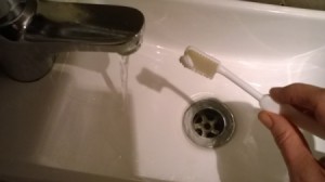 small size dab of toothpaste on brush