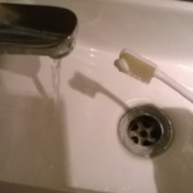 small size dab of toothpaste on brush