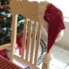 Santa hat on back of chair next to Christmas tree