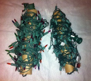 Two rolls of Christmas lights on paper tubes.