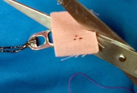 using scissors to cut out face from fabric