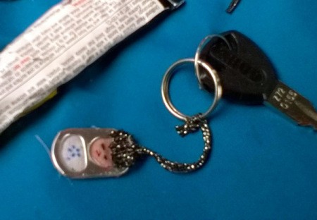 finished key fob with car key ring  attached and cord glued, closeup photo