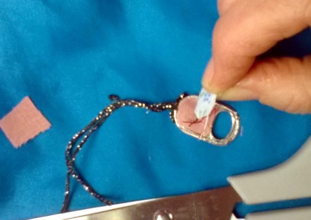 second piece of fabric has been cut to fit other opening on tab and now glued