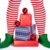 Striped elf legs over a pile of presents.